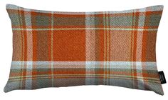 an orange plaid pillow on a white background