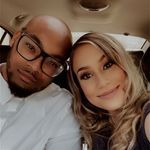 a man and woman taking a selfie in the back seat of a car