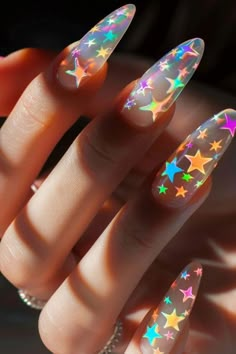 If you’re looking for a nail design that’s both enchanting and trendy, look no further than star nail designs. These mesmerizing looks capture the whimsy and wonder of the night sky, allowing you to carry Euphoria Nail Designs, Black Opal Nails, Colorful Star Nails, Colorful Nails Acrylic, Long Nails Aesthetic, Claw Nails Designs, Weather Nails, Cosmic Nails, Star Nail Designs