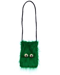 a green furry bag with eyes on the front and black string hanging from it's side