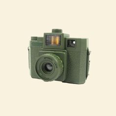 an old green camera is shown against a white background