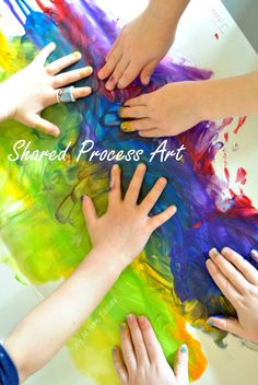 hands on top of colorful paint with the words shared process art written in white letters