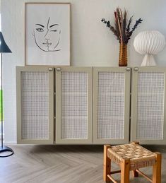 a living room with a chair, table and pictures on the wall above it's doors