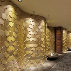 a room that has some gold tiles on the wall and two vases next to it