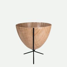 a wooden bowl sitting on top of a metal stand