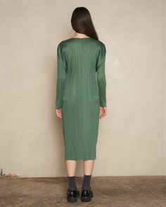 Long sleeve pleated dress by Pleats Please Issey Miyake in moss green. Mid-length dress crafted in glossy polyester with signature heat-treated pleating. Detailed by long sleeves and a wide V-neckline. 100% Polyester.Made in Japan. Pictured with Chunky Mary Janes Shoes by MM6 Maison Margiela. Dark Green Fitted Long Sleeve Midi Dress, Fitted Long Sleeve Dark Green Midi Dress, Fitted Dark Green Long Sleeve Midi Dress, Green Midi-length Long Sleeve Evening Dress, Green Long Sleeve Midi Dress For Formal Events, Spring Long Sleeve Midi Dress With Folds, Green Fitted Pleated Evening Dress, Green Fitted Pleated Dress For Evening, Green Long Sleeve Midi Dress For Fall