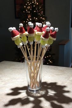 a glass filled with marshmallows and santa hats