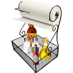 a metal basket with bottles and spices in it next to a roll of toilet paper