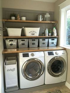 a washer and dryer in a laundry room with baskets on the shelves above them