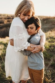 two women hugging each other in a field