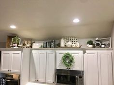 a kitchen with white cabinets and an oven