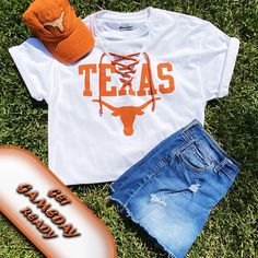 "Texas longhorn game day tee with a new twist on an ordinary tee.  The v-neck is cut out, little holes are cut to thread the knit burnt orange lace up.  You can leave the tee long, have it cut off or cut with a front tie.  At check out, you can choose from original hem, crop (21\" from back neck line) or crop with front ties. If you would like grommets to line the v-neck instead of little holes, please include that on your order by typing your request.  100% cotton tee, machine wash, line dry.  Made in Texas with ❤️! https://seamsewdistinctive.etsy.com/listing/1588296750" Texas Tailgate Outfit, Texas Longhorn Shirt Ideas, Longhorns Game Day Outfit, Texas Longhorns Game Day Outfit, White T-shirt For Summer Fan Gear, Texas Longhorns Shirts, Original Hem, Tailgate Outfit, Game Day Outfit