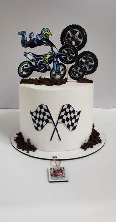 a cake decorated with dirt bikes and checkered flags