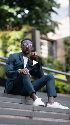 a man sitting on some steps with his legs crossed