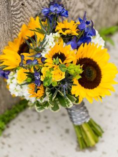 a bouquet of sunflowers and blue flowers