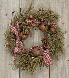 a christmas wreath with pine cones and ornaments