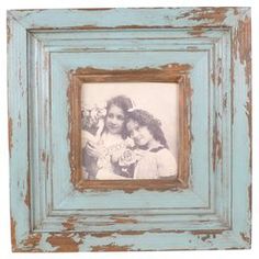 an old blue frame with two girls holding flowers