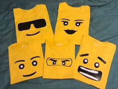 four yellow shirts with faces drawn on them