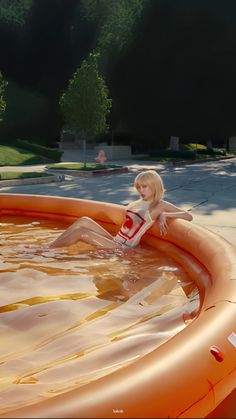 a woman sitting on top of an inflatable swimming pool next to a park