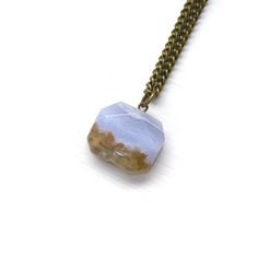 Take in the beauty of this blue lace agate square slab necklace. Add a boho beach vibe to your favorite summer look with this one-of-a-kind statement piece that resembles a gorgeous ocean scene. ITEM DETAILS: Natural gemstone - blue lace agate Nickel free Brass chain - not plated, so it won't tarnish 18 inches in length One-of-a-kind Gemstone info card included Gift ready - placed on a branded jewelry card and wrapped in an organic cotton jewelry pouch, that doubles as a stone polishing cloth GE Bohemian Agate Necklace With Raw Stone, Bohemian Agate Raw Stone Necklace, Bohemian Blue Necklace With Raw Stone, Bohemian Rectangular Necklace For Gift, Bohemian Style Rectangular Necklace For Gifts, Handmade Agate Necklace For Beach, Bohemian Blue Necklace With Rectangular Pendant, Bohemian Adjustable Necklace With Square Pendant, Bohemian Necklace With Adjustable Square Pendant