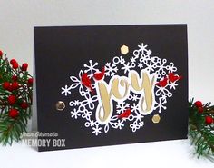 a christmas card with the word joy on it and snowflakes in the background