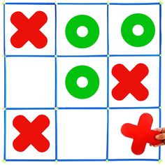 a person is playing with a tic - tac - toe game on a white background