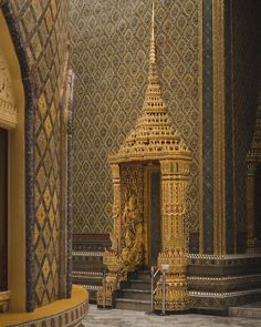 an ornate gold and black building with stairs