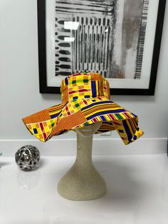 Enjoy our over sized African print sun hat this summer!! Hat with its wide range brim makes it very useful as a beach hat without compromising on fashion! Your Ankara hat is not too big or too small; Just the right statement piece! Not crazy about the beach? Wear it to your cookouts or fun garden party or outdoor festivals with your favorite solid colored outfits. *Hats will arrive folded and can be ironed to take any creases out or wear it just the way it falls with folds. *Lighting may alter c Multicolor Brimmed Hat With Uv Protection, Multicolor Short Brim Hat With Uv Protection, Trendy Yellow Sun Hat For Vacation, Multicolor Curved Brim Bucket Hat For Summer, Fun Adjustable Wide Brim Bucket Hat, Trendy Multicolor Hats With Uv Protection, Fun Fedora Sun Hat For Vacation, Yellow Bucket Hat With Short Brim For Vacation, Fun Fedora Sun Hat For The Beach