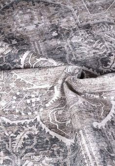 a close up view of the fabric on a bed sheet that has been made to look like an old rug