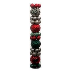 a tall stack of christmas ornaments on top of each other in red, green and silver