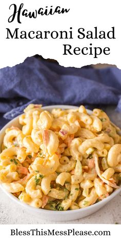 a bowl filled with macaroni salad on top of a table next to a blue towel