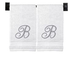 two white towels with the letter b on them