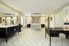 a large bedroom with white and black furniture