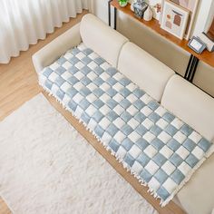 a living room with a couch and rug on the floor