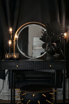 a table with a mirror and some candles on it