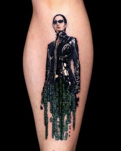 a woman's leg with an inked image of a man in black and green