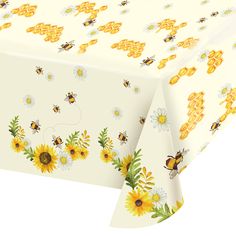 a table cloth with bees and sunflowers on it