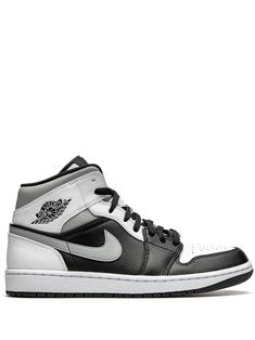 the air jordan 1 mid is available in black and white, with an upper - cut outs