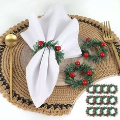 a place setting with napkins, forks and christmas decorations