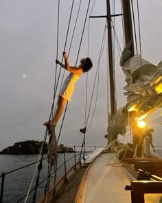 a man standing on top of a sail boat