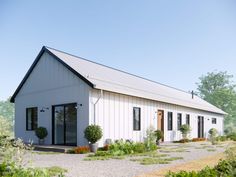 a small white building sitting on top of a lush green field