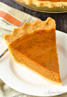 a slice of pumpkin pie on a white plate