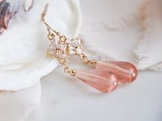 "These beautiful art deco earrings are created with wire wrapped pink glass teardrops and accented with tiny cubic zirconia fans. These are secured to dainty 14k gold filled earring wires for a comfortable all day wear. These simple yet elegant pink wedding earrings are the perfect beach wedding, rustic wedding accessory for your bridesmaids and compliment many boho bridal attire adding a dose of subtle glam to your wedding day. Your boho bridal earrings will arrive suitably gift wrapped ready f Delicate Pink Party Earrings, Handmade Pink Crystal Earrings For Wedding, Elegant Wire Wrapped Teardrop Earrings For Wedding, Wedding Crystal Drop Earrings Wire Wrapped, Wire Wrapped Crystal Drop Earrings For Wedding, Wire Wrapped Drop Earrings For Wedding, Wedding Wire Wrapped Crystal Drop Earrings, Elegant Peach Earrings For Wedding, Elegant Peach Wedding Earrings