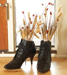 a pair of black high heeled shoes sitting on top of a wooden floor