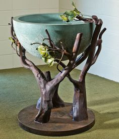 a planter that is sitting on top of a wooden stand with trees growing out of it