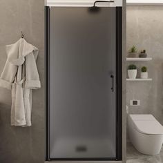 a bathroom with a glass shower door and towel racks on the wall next to it