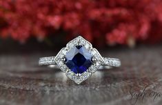 an engagement ring with a blue stone surrounded by diamonds