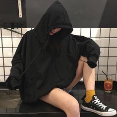 a woman sitting on top of a black counter