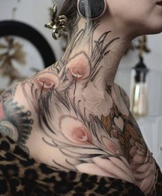 a woman with tattoos on her neck and chest