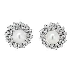 Behold the epitome of elegance and luxury with the Van Cleef & Arpels Estate Diamond and Pearl Bombe Earrings, a breathtaking testament to the artistry of fine jewelry. Crafted in exquisite 18k white gold, these earrings exude an aura of timeless sophistication that is synonymous with the Van Cleef & Arpels legacy. At the heart of these masterpieces lies a luminous white pearl, commanding attention with its impressive 16mm diameter. The pearl's pristine radiance is further enhanced by the opulence of its surroundings – a halo of meticulously arranged marquise-cut diamonds. With a total carat weight of approximately 20.00cttw, these diamonds glisten like celestial stars, adding an awe-inspiring brilliance to the earrings. The unique bombe design of the earrings accentuates their regal prese